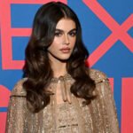 Kaia Gerber pairs opulent glitter with casual knee-highs